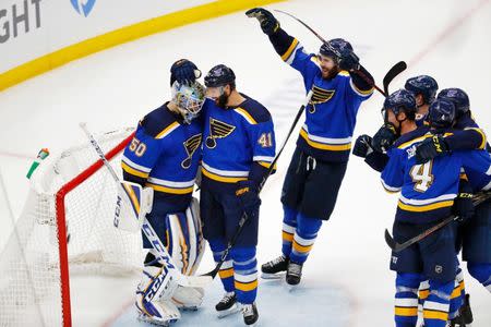 May 21, 2019; St. Louis, MO, USA; St. Louis Blues goaltender Jordan Binnington (left) and defenseman Robert Bortuzzo (41) celebrate their win over the San Jose Sharks in game six of the Western Conference Final of the 2019 Stanley Cup Playoffs at Enterprise Center. The St. Louis Blues won 5-1. Mandatory Credit: Billy Hurst-USA TODAY Sports