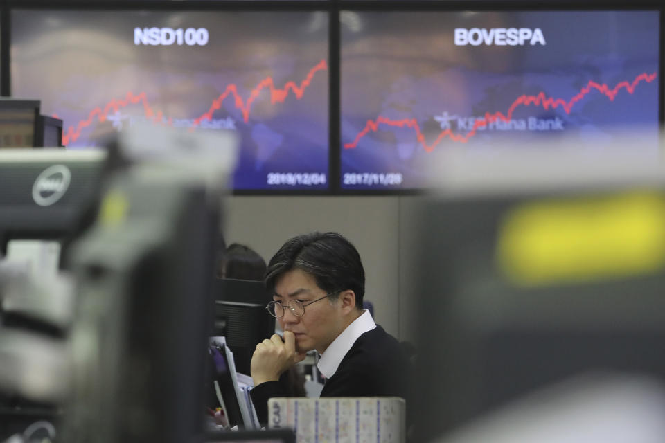 A currency trader watches monitors at the foreign exchange dealing room of the KEB Hana Bank headquarters in Seoul, South Korea, Thursday, Dec. 5, 2019. Asian shares were rising Thursday amid renewed hopes a U.S. trade deal with China may be nearing, despite tough recent talk from President Donald Trump.(AP Photo/Ahn Young-joon)