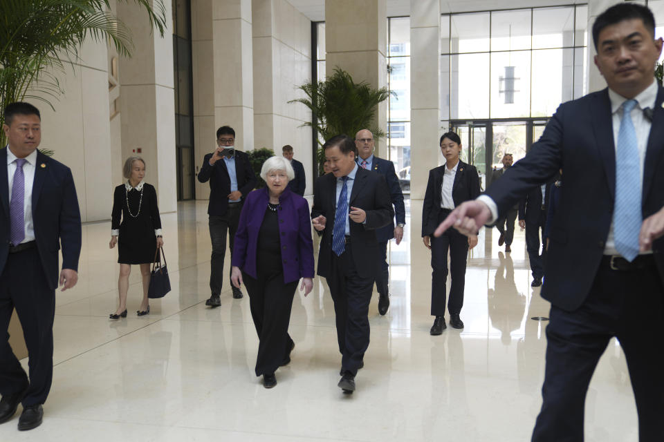 U.S. Treasury Secretary Janet Yellen, center left, walks with Governor of the People's Bank of China Pan Gongsheng as they meet at the People's Bank of China in Beijing Monday, April 8, 2024. (AP Photo/Tatan Syuflana, Pool)