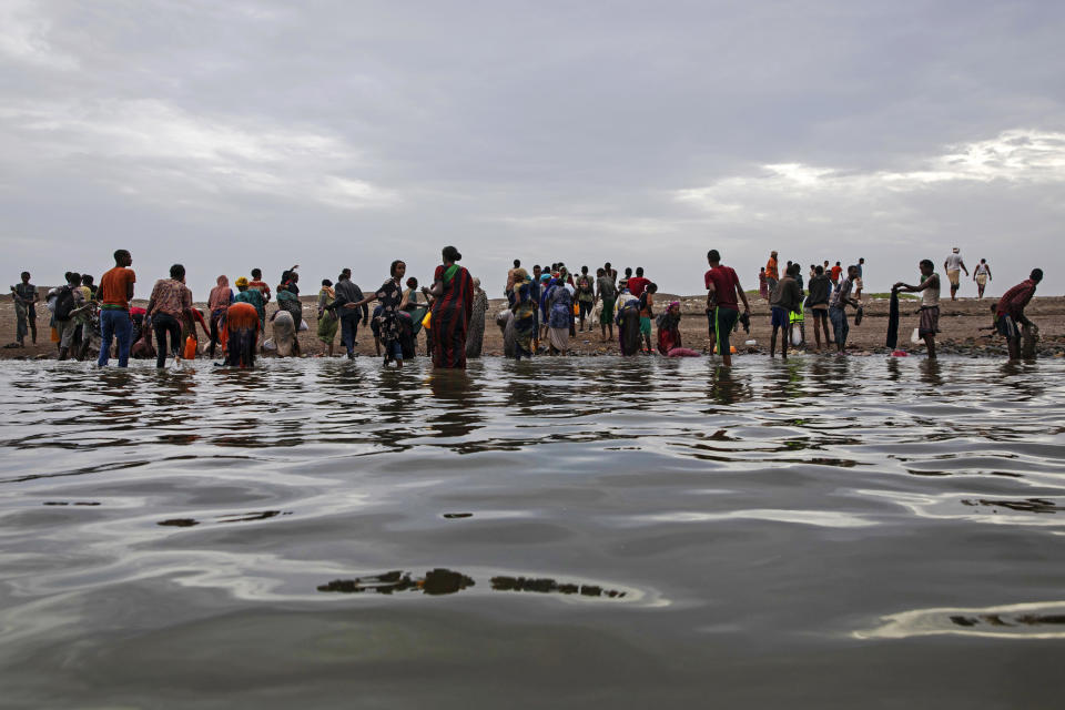 A file photo from July 2019 shows Ethiopian migrants walking along the shores of Ras al-Ara, Lahj, Yemen, after disembarking from a boat.  According to the UN immigration agency, a boat carrying migrants sank off the coast of Yemen on June 10, 2024, killing at least 39 people and leaving dozens of others missing.  /Credit: Nariman El-Mofty/AP