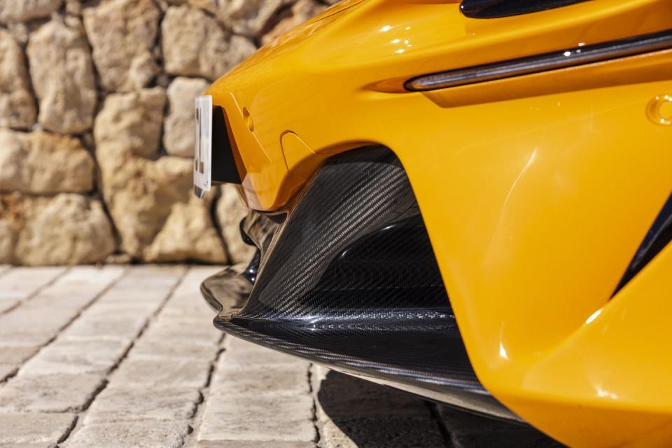 a yellow car parked on a brick road