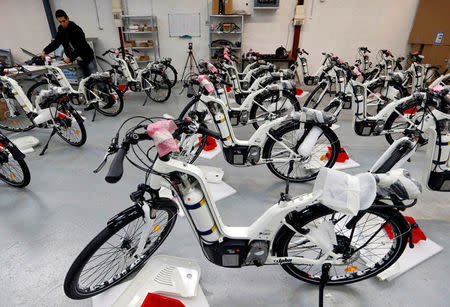 An employee inspects an Alpha bike, the first industrialised bicycle to use a hydrogen fuel cell at the Pragma Industries factory in Biarritz, France, January 15, 2018. REUTERS/Regis Duvignau