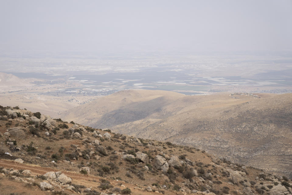 An Israeli settlers' outpost on a hilltop, right, is seen from outskirts of the West Bank town of Duma, Tuesday, April 30, 2024. (AP Photo/Nasser Nasser)