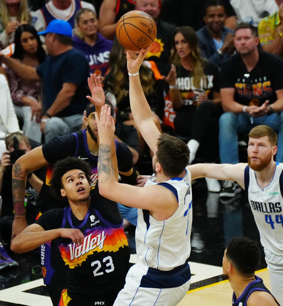 May 4, 2022; Phoenix, Arizona; USA; Suns' Cameron Johnson (23) defends Mavericks' Luka Doncic (77) during the first half of Game 2 in the second round of the Western Conference Playoffs.