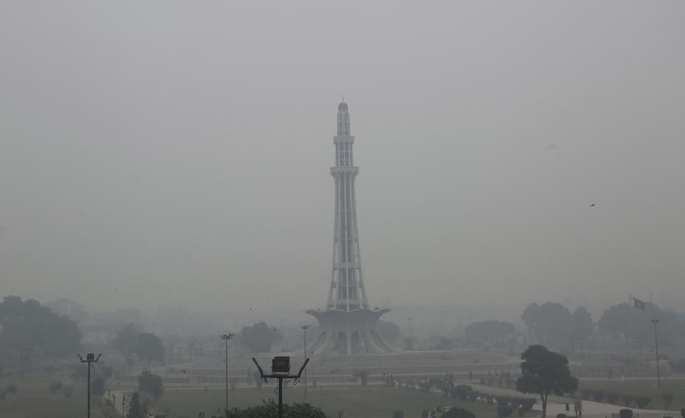 Heavy smog blankets the Pakistan Monument, in Lahore, Pakistan, Thursday, Nov. 21, 2019. Amnesty International issues "Urgent Action" saying every person in Lahore at risk. Heavy smog has enveloped many cities of Punjab province, causing highway accidents and respiratory problems, and forcing many residents to stay home. (AP Photo/K.M. Chaudary)