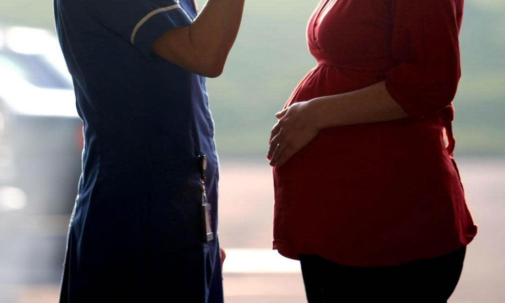 Stock picture of pregnant woman with midwife.