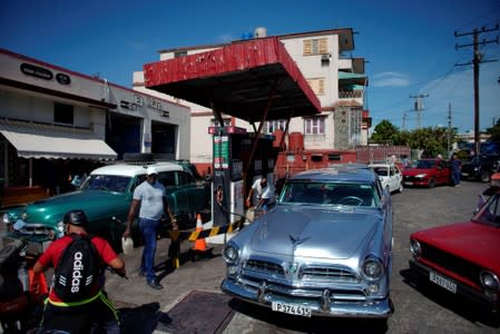 Cars line-up to buy fuel at a gas station in Havana