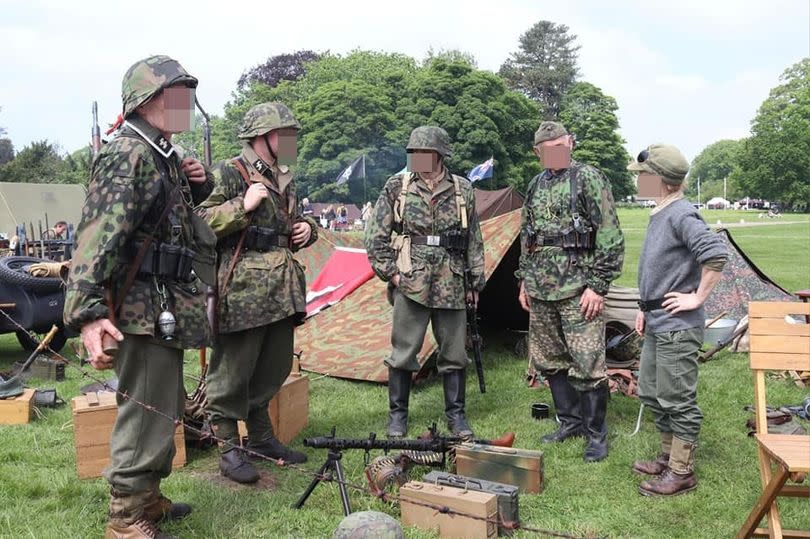 A group dressed in Waffen-SS uniforms