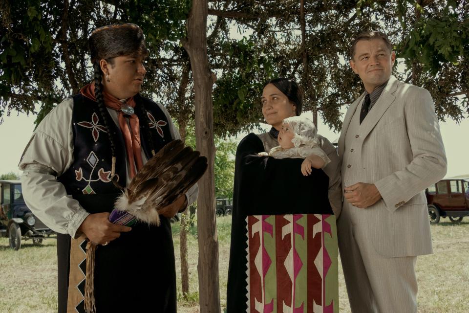 From left, Christopher Cote, Lily Gladstone and Leonardo DiCaprio appear in a scene from the movie in “Killers of the Flower Moon." Cote is wearing a vest adorned with intricate beadwork by Oklahoma artist Molly Murphy Adams, who is Oglala Lakota.