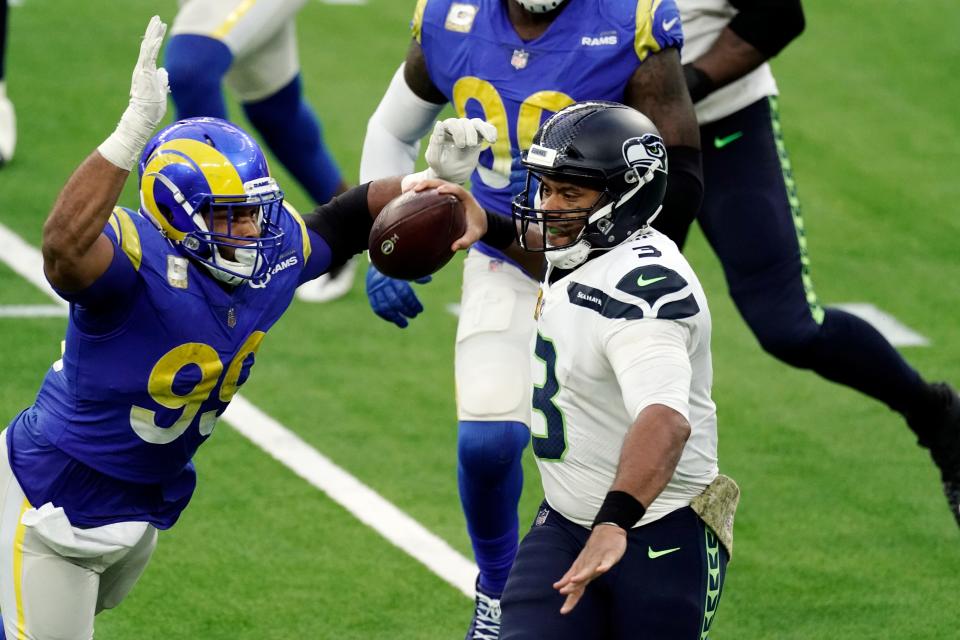 Seahawks Russell Wilson throws under pressure from Rams defensive end Aaron Donald during the second half of Sunday's NFC West showdown.