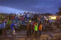 People watch rescue operations at the site of passenger trains that derailed in Balasore district, in the eastern Indian state of Orissa, Saturday, June 3, 2023. Rescuers in India have found no more survivors in the overturned and mangled wreckage of two passenger trains that derailed, killing more than 280 people and injuring hundreds in one of the country’s deadliest rail crashes in decades. (AP Photo/Rafiq Maqbool)