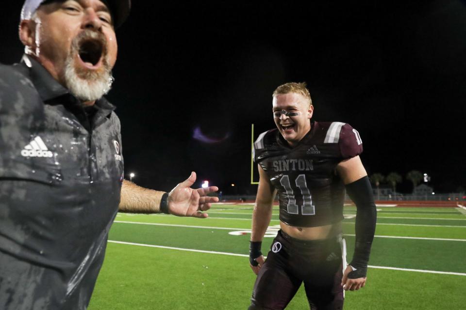 Sinton head football coach Michael Troutman is doused with a cooler of ice water after the game at Pirate Stadium on Friday, Nov. 3, 2023, in Sinton, Texas. Aidan Moody laughs.
