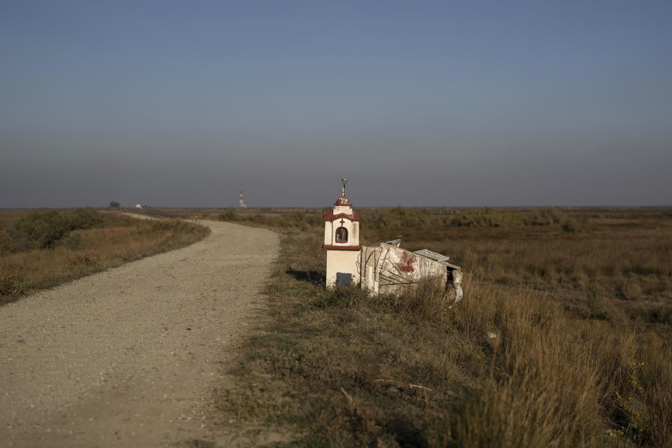 A roadside shrine stands at the Evros Delta that forms a natural border between Greece and Turkey, on Sunday, Oct. 30, 2022. Greece is planning a major extension of a steel wall along its border with Turkey in 2023, a move that is being applauded by residents in the border area as well as voters more broadly. (AP Photo/Petros Giannakouris)