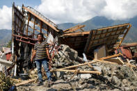 Kaharuddin, 40, waits for excavators to dig up a pile of concrete that used to be his home and was destroyed by an earthquake in Balaroa neighbourhood, Palu, Central Sulawesi, Indonesia, October 10, 2018. REUTERS/Jorge Silva