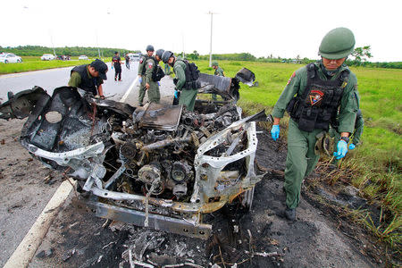 Military personnel search the site of a roadside bomb blast in the southern province of Pattani, Thailand August 16, 2017. REUTERS/Surapan Boonthanom