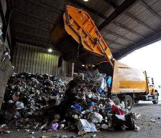 A City of Erie Bureau of Refuse truck dumps a load of garbage off at the Greater Erie Transfer Station in Erie in this 2014 file photo.