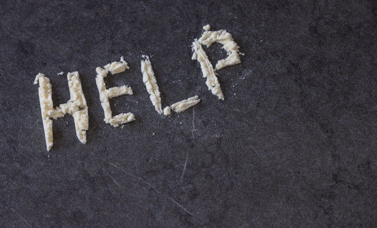 The word HELP spelled out in white powder