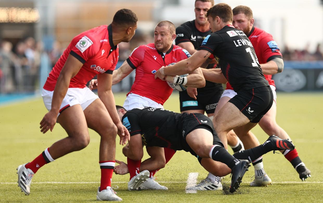 Mike Brown is held up during a Gallagher Premiership match between Saracens and Newcastle Falcons - GETTY IMAGES