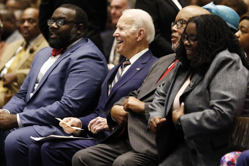 Democratic presidential candidate and former Vice President Joe Biden, center, U.S. Rep. Bennie Thompson, D-Miss., second from right, B.J. Thompson, the congressman's daughter, right, and Trey Baker, with the Biden campaign, left, laugh at comments from Pastor Jerry Young during services at New Hope Baptist Church, Sunday, March 8, 2020, in Jackson, Miss. (AP Photo/Rogelio V. Solis)