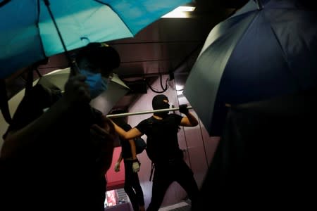 Anti-government protesters vandalise the metro entrance in Causeway Bay district in Hong Kong