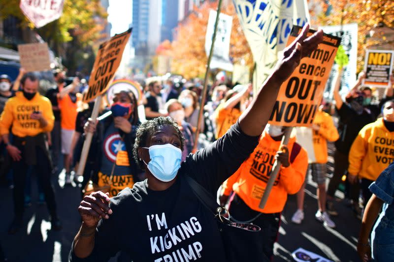 Activists dance in celebration after Democratic presidential nominee Joe Biden overtook President Donald Trump in the Pennsylvania general election vote count in Philadelphia