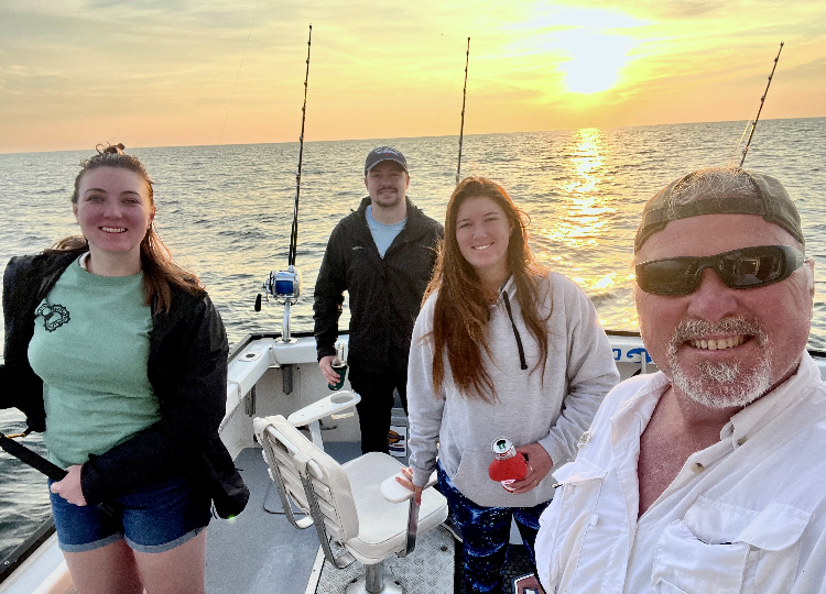 Robert Addie, right, of Portsmouth and family members enjoy a day boating off the coast of Cape Cod on Monday, July 24, 2023, when they saw three whales breach at once. From left are his daughter Sage Addie, son-in-law Josh Wally-Addie and daughter Neve Addie.