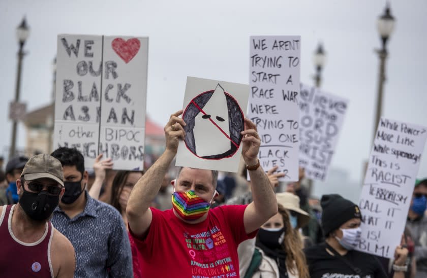 HUNTINGTON BEACH, CA - APRIL 11: Protesters gather for a Black Lives Matter rally on Sunday, April 11, 2021 in Huntington Beach, CA. (Brian van der Brug / Los Angeles Times)