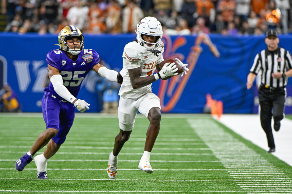 NEW ORLEANS, LA - JANUARY 01: Texas Longhorns wide receiver Xavier Worthy (1) finishes a catch as Washington Huskies cornerback Elijah Jackson (25) gives chase during the Semifinal All State Sugar Bowl football game between the Texas Longhorns and Washington Huskies at the Caesars Superdome on January 1, 2024 in New Orleans Louisiana. (Photo by Ken Murray/Icon Sportswire via Getty Images)