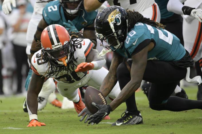 Jacksonville Jaguars cornerback Shaquill Griffin (26) recovers fumble by Cleveland Browns running back D'Ernest Johnson (30) during the first half of an NFL preseason football game, Friday, Aug. 12, 2022, in Jacksonville, Fla. (AP Photo/Phelan M. Ebenhack)