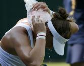 Belinda Bencic of Switzerland cools down with an icebag during her match against Anna-Lena Friedsam of Germany at the Wimbledon Tennis Championships in London, July 1, 2015. REUTERS/Stefan Wermuth