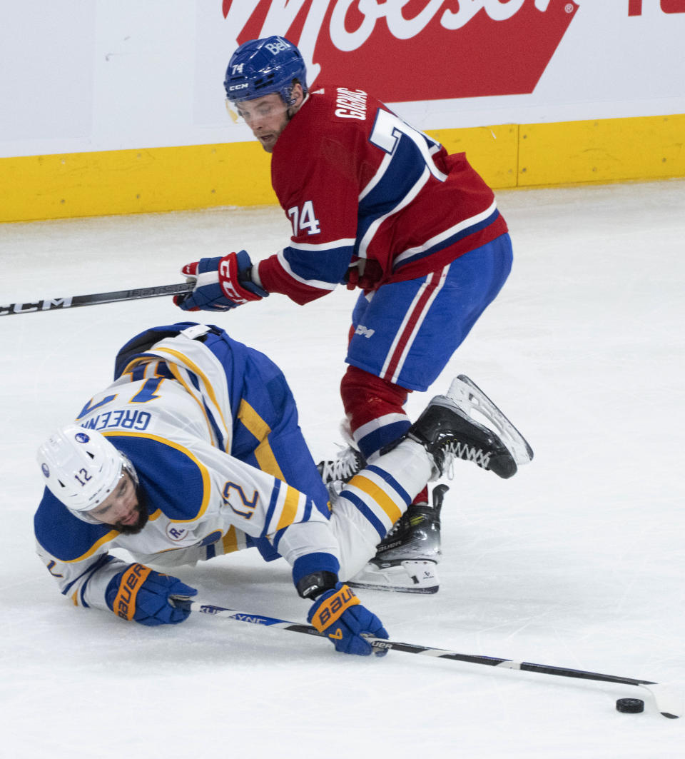 Montreal Canadiens' Brandon Gignac (74) and Buffalo Sabres' Jordan Greenway (12) vie for the puck during the second period of an NHL hockey game Wednesday, Feb. 21, 2024, in Montreal. (Christinne Muschi/The Canadian Press via AP)