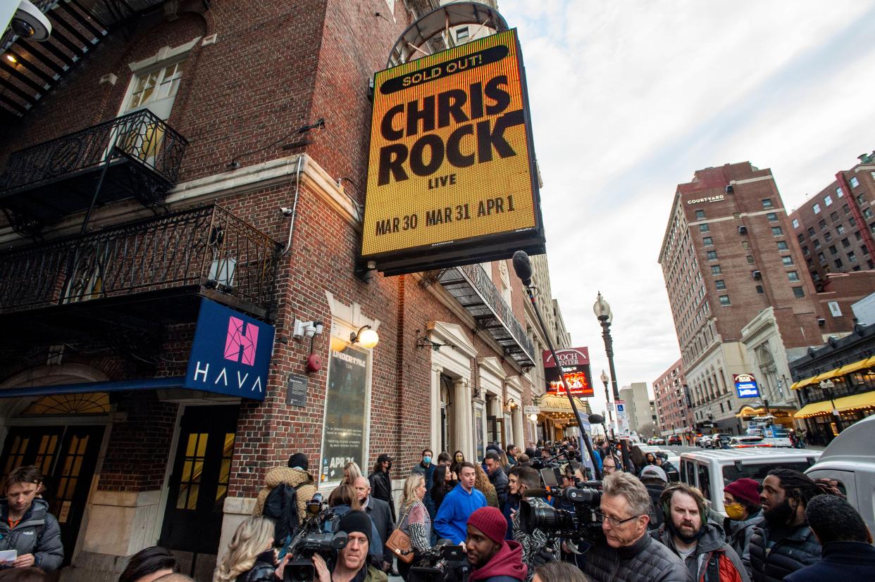 People wait in line to enter the Wilbur Theatre for a sold out performance by US comedian Chris Rock in Boston, Massachusetts on March 30, 2022.