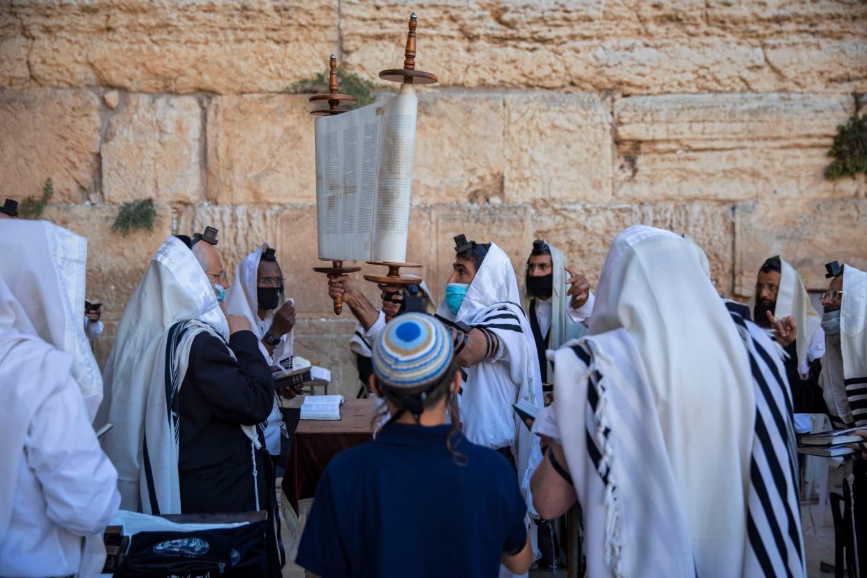 Ultra-Orthodox Jewish men wear protective face masks during morning prayer at the Western Wall, the holiest site where Jews can pray, in Jerusalem's Old City on Thursday, July 16, 2020. The Western Wall plaza is divided to sections which allow a maximum twenty people following the government's measures to help stop the spread of the coronavirus.