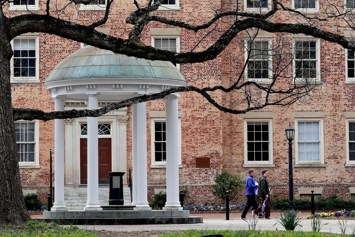 In this March 18, 2020 file photo, people remove belongings on campus at the University of North Carolina in Chapel Hill, N.C. A federal judge has ruled that North Carolina’s flagship public university may continue to consider race as a factor in its undergraduate admissions. The ruling goes against plaintiffs who argued that race-based admissions put white and Asian students at a disadvantage. U.S. District Judge Loretta Biggs ruled late Monday, Oct. 18, 2021 that the University of North Carolina has shown that it has a compelling reason to pursue a diverse student body and has demonstrated that measurable benefits come from that goal.