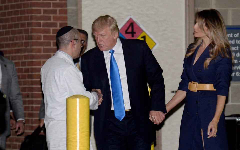 President Donald Trump and First Lady Melania Trump shake hands with Doctor Ira Rabin as they leave the MedStar Washington Hospital Centre  - Credit: EPA