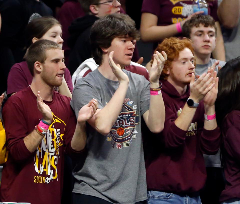 Brandywine seniors Duane Thompson, Brady Wright and Bode Bosch cheer on the Bobcats during the MHSAA Division 3 girls basketball state championship game Saturday, March 23, 2024, at the Breslin Center in East Lansing, Mich.
