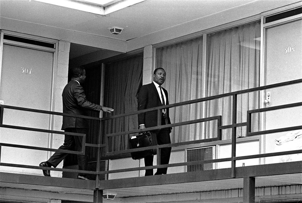 <p>Dr. Martin Luther King Jr. walks across the balcony of the Lorraine Motel shortly after arriving in Memphis, Tenn., on April 3, 1968, at approximately the spot where he was shot by a hidden assassin on April 4, 1968. (Photo: Charles Kelly/AP) </p>