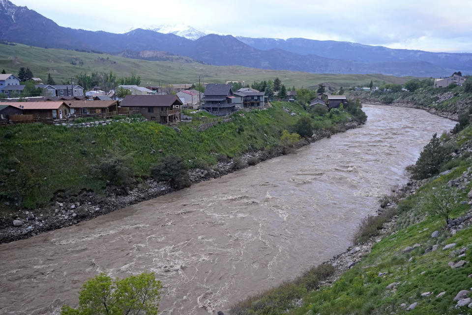 The Yellowstone River flows through Gardiner, Mont., Wednesday, June 15, 2022. Yellowstone National Park officials say more than 10,000 visitors have been ordered out of the nation's oldest national park after unprecedented flooding tore through its northern half, washing out bridges and roads and sweeping an employee bunkhouse miles downstream. (AP Photo/Rick Bowmer)