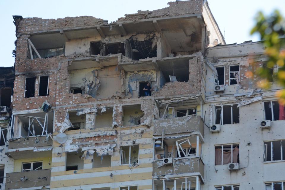 A man salvages belongings in a destroyed apartment on the upper floors of a residential building hit by drones on May 30, 2023 in Kyiv, Ukraine. (Oleksandr Gusev/Global Images Ukraine via Getty Images)