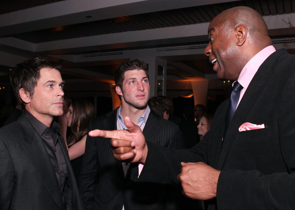 Actor Rob Lowe, from left, NFL football player Tim Tebow and former NBA basketball player Earvin "Magic" Johnson attend LL Cool J's pre-Grammy party hosted by Hennessy, on Saturday, February 11, 2012 in Los Angeles.  (Chris Weeks /AP Images for Hennessy)