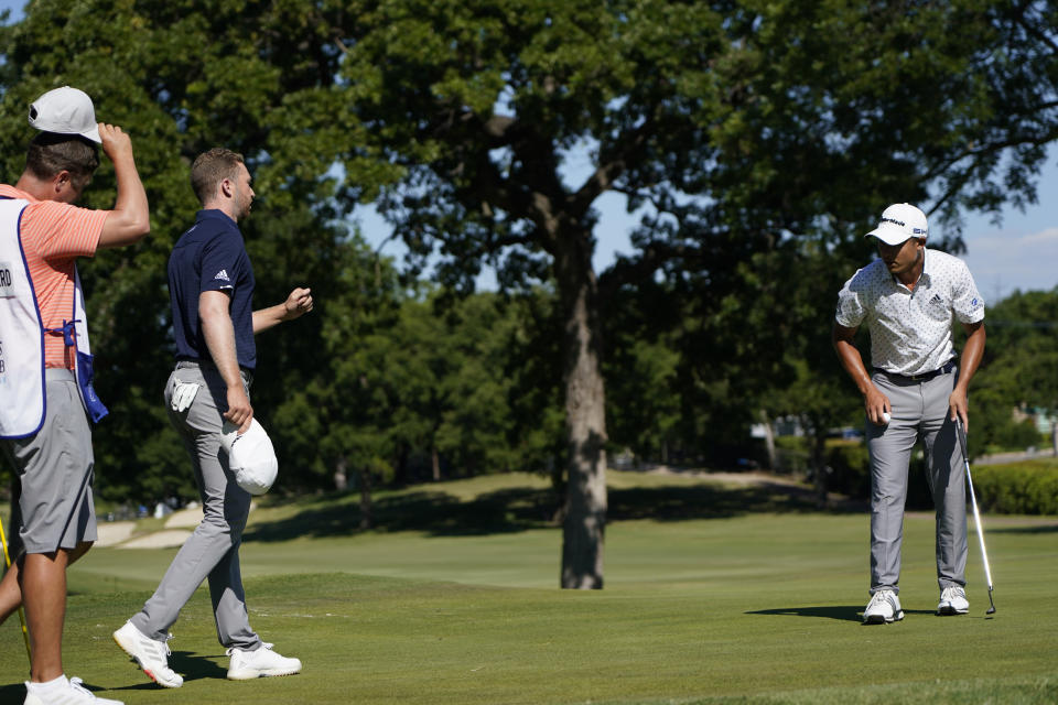 Daniel Berger, second left, walks over to Coilin Morikawa after winning Charles Schwab Challenge golf tournament at the Colonial Country Club in Fort Worth, Texas, Sunday, June 14, 2020. Morikawa missed his putt on the first playoff hole. (AP Photo/David J. Phillip)