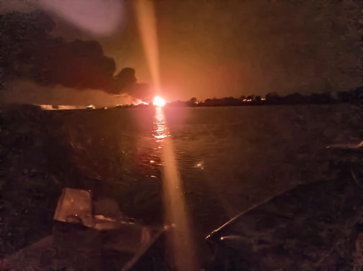 A fireball lights the horizon on the Ukrainian shore of the Danube, seen from Chilia Veche in eastern Romania
