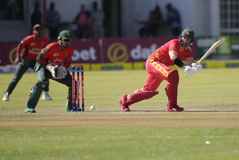 Zimbabwe batsman Burl Ryan,right, plays a shot on the final day of the T20 match between Zimbabwe and Bangladesh at Harare Sports Club in Harare, Zimbabwe, Sunday, July 31, 2022. (AP Photo/Tsvangirayi Mukwazhi)