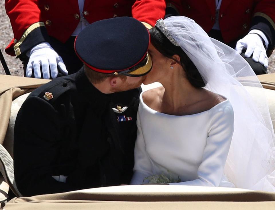 <p>During the royal procession to Windsor Castle following their royal wedding on 19 May 2018, Prince Harry couldn't help share a kiss with his bride en route, making this their second public royal kiss together since their wedding, May 2018. </p>