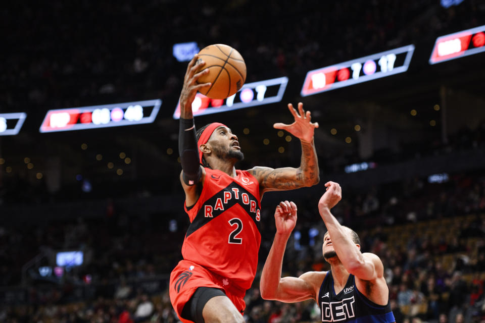 Toronto Raptors forward Jalen McDaniels (2) scores a lay up over Detroit Pistons forward Kevin Knox II (24) during the second half of an NBA basketball game, in Toronto, Sunday, Nov. 19, 2023. (Christopher Katsarov/The Canadian Press via AP)