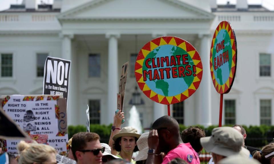 Protesters carry signs during the People’s Climate March at the White House in Washington.