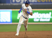 Kansas City Royals' Nicky Lopez sprints to third base on his way to scoring on a double by teammate Whit Merrifield during the sixth inning of a baseball game against the Boston Red Sox in Kansas City, Mo., Friday, June 18, 2021. (AP Photo/Reed Hoffmann)
