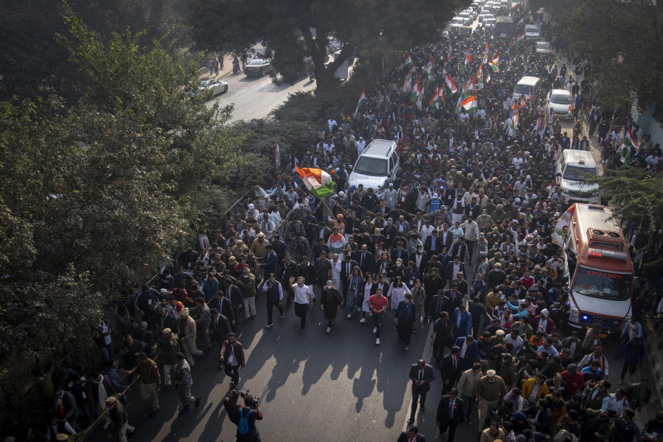 India's opposition Congress party leaders Rahul Gandhi, left in white T-shirt, Sonia Gandhi, centre wearing a face mask, and Priyanka Gandhi, right, walk with their supporters during a march, in New Delhi, India, Saturday, Dec. 24, 2022. Rahul Gandhi, leader of India's beleaguered opposition Congress party, on Saturday marched in New Delhi along with his supporters, part of his five-month-long 3,570km (2,218-mile) countrywide trek through 12 states that began 105 days ago.(AP Photo/Altaf Qadri)