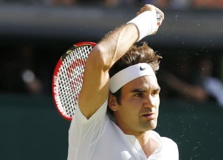 Roger Federer of Switzerland hits a shot during his match against Andy Murray of Britain at the Wimbledon Tennis Championships in London, July 10, 2015. REUTERS/Suzanne Plunkett