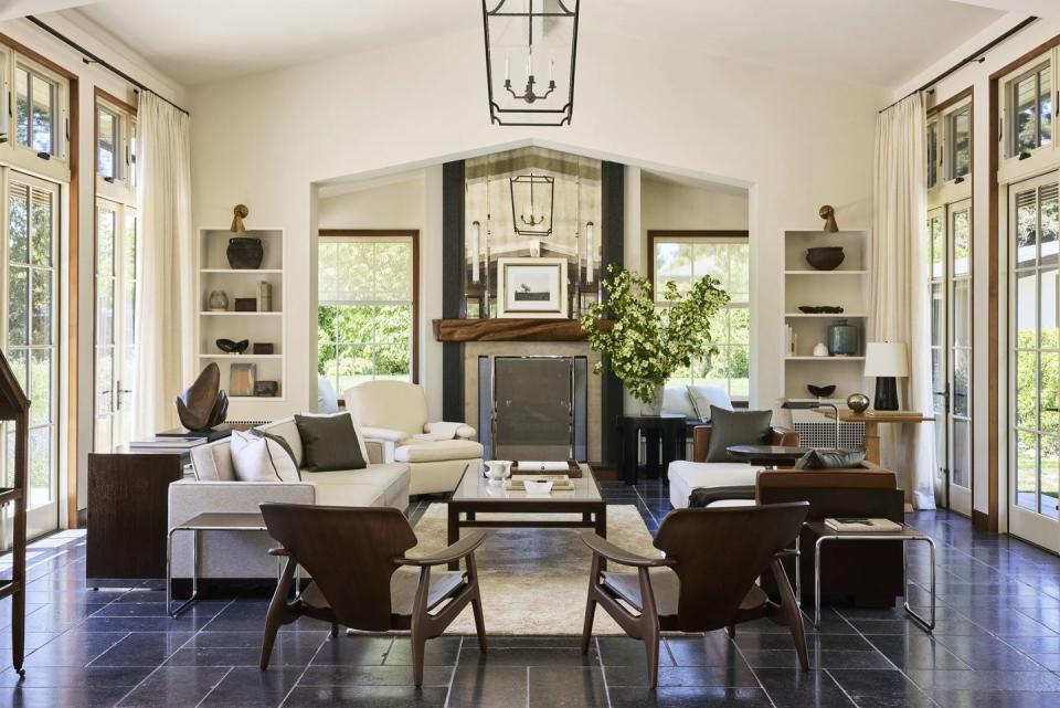 a newly added great room opens to a pool and a shaded dining area